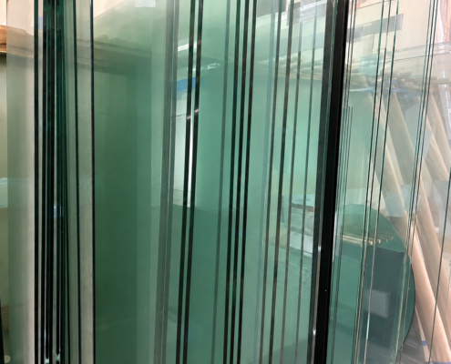 Glass shower doors panels in racks ready for installation